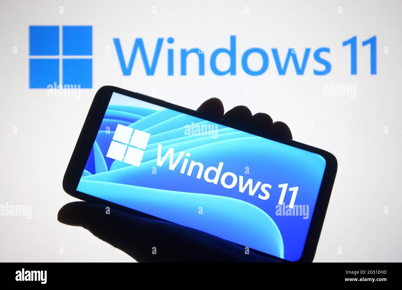 Ukraine. Juni 2021. In dieser Abbildung ist ein Windows 11-Logo auf einem Smartphone und ein pc-Bildschirm im Hintergrund zu sehen.Microsoft hat Windows 11, die neue Generation des Windows-Betriebssystems (OS), während einer Veranstaltung am 24. Juni 2021 vorgestellt. (Foto von Pavlo Gonchar/SOPA Images/Sipa USA) Quelle: SIPA USA/Alamy Live News Stockfoto