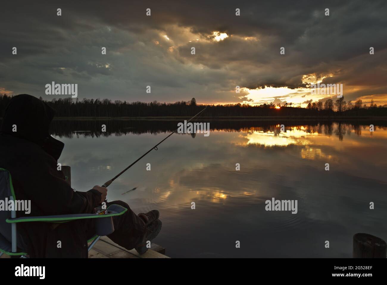 Fischer Angeln im Sonnenuntergang, Nachtfischen Schönheit, Lettland Stockfoto