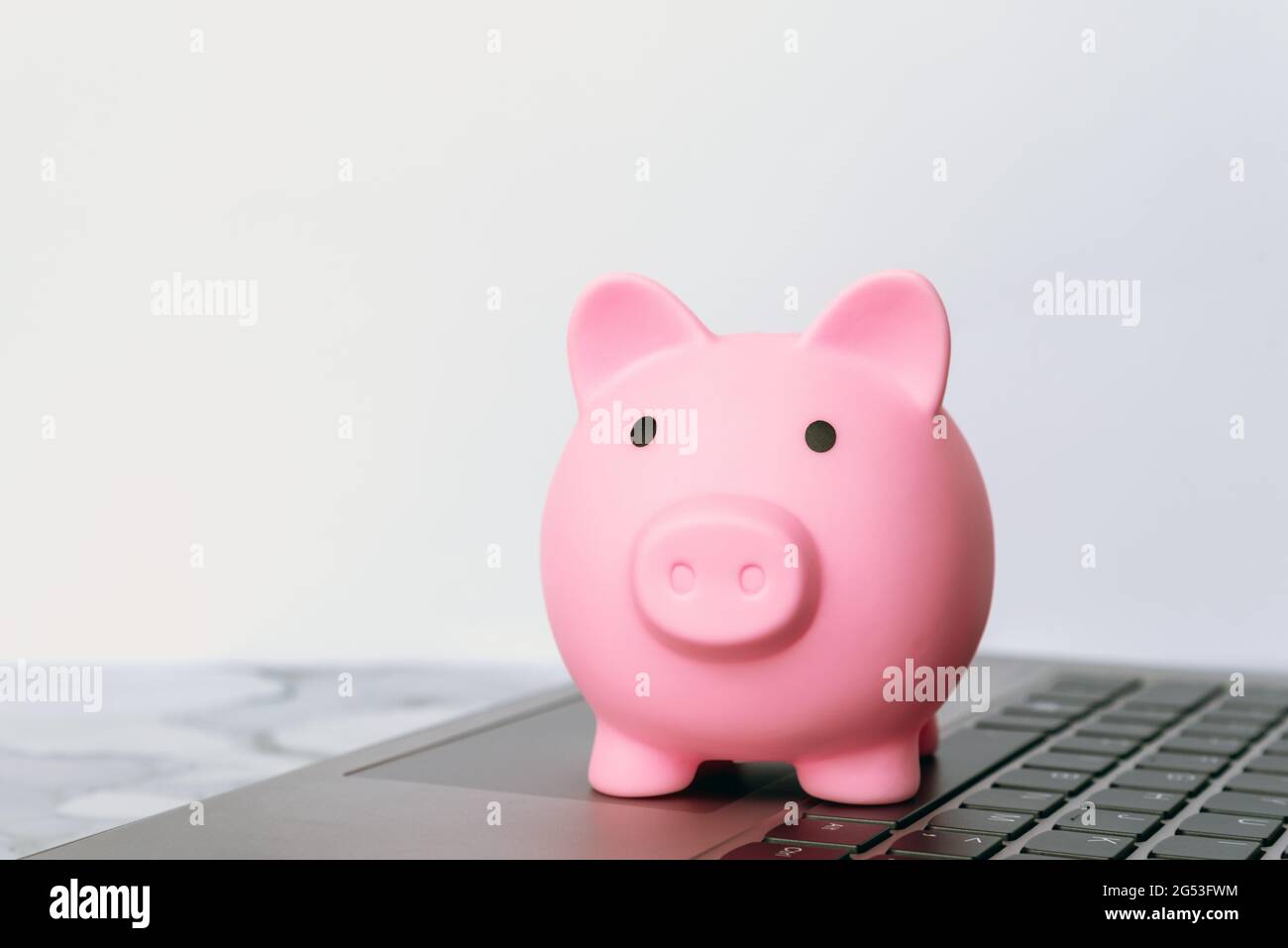 Sparschwein auf der oberen Laptop-Tastatur Stockfoto