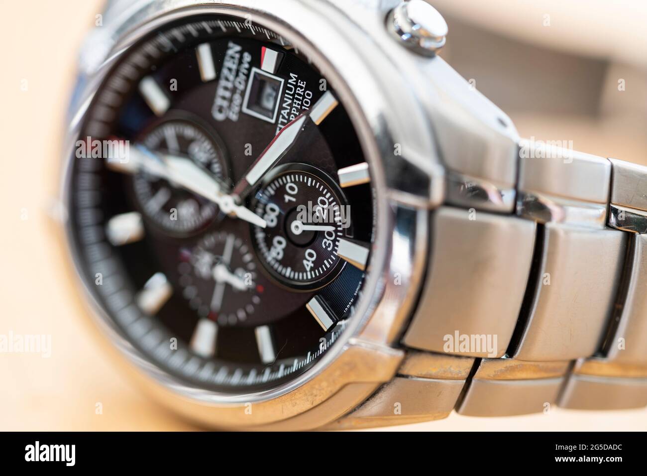 Nahaufnahme eines Citizen Eco Drive solarbetriebenen Titan-Metall-Mann-Armbanduhrs mit Zeigern für Uhrzeiger und das Metallarmband Stockfoto