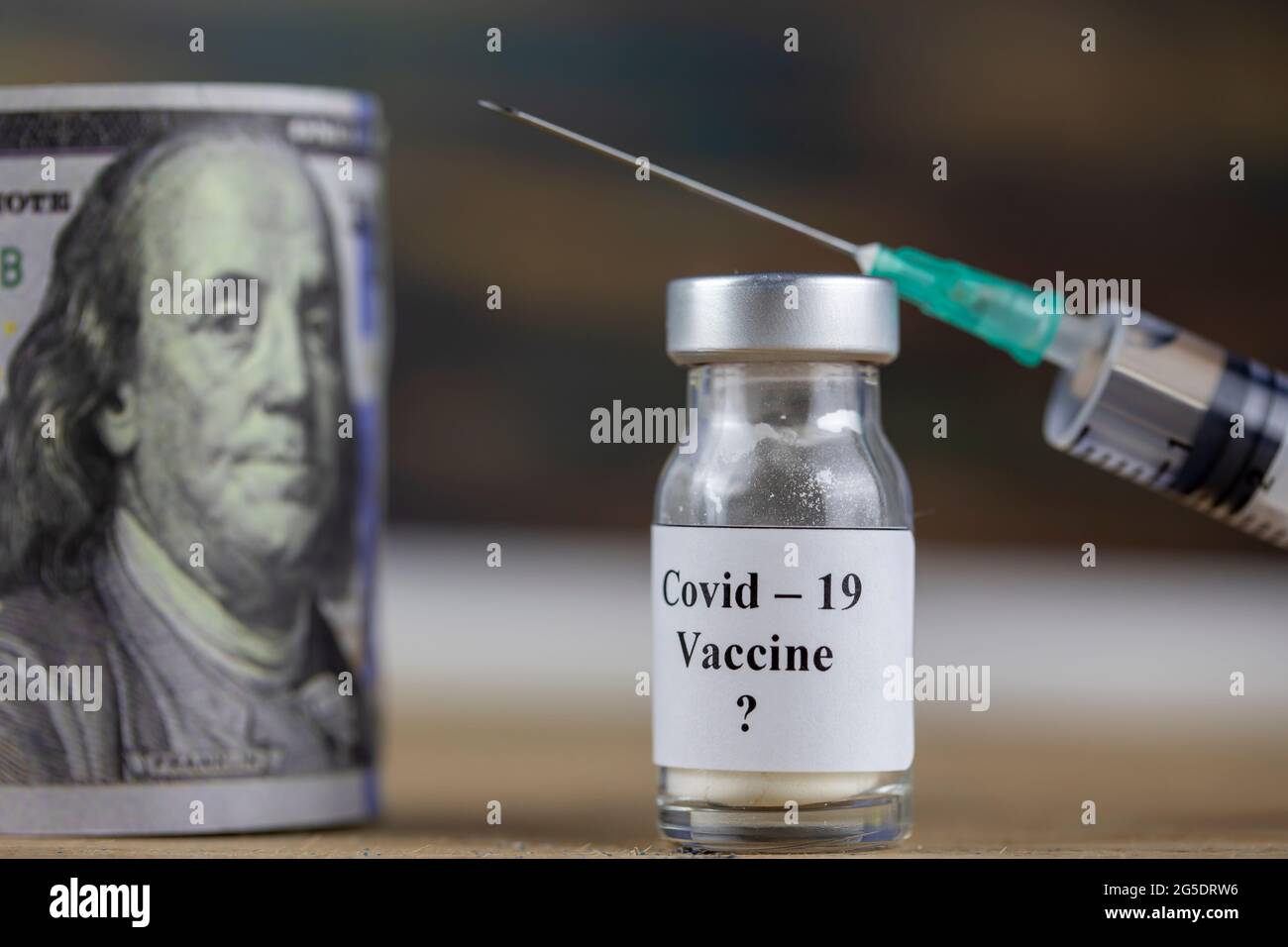 Pandemiekonzept und Geld ( Dollar) zu impfen. Impfstoffflasche mit Spritze für Covid-19 Stockfoto