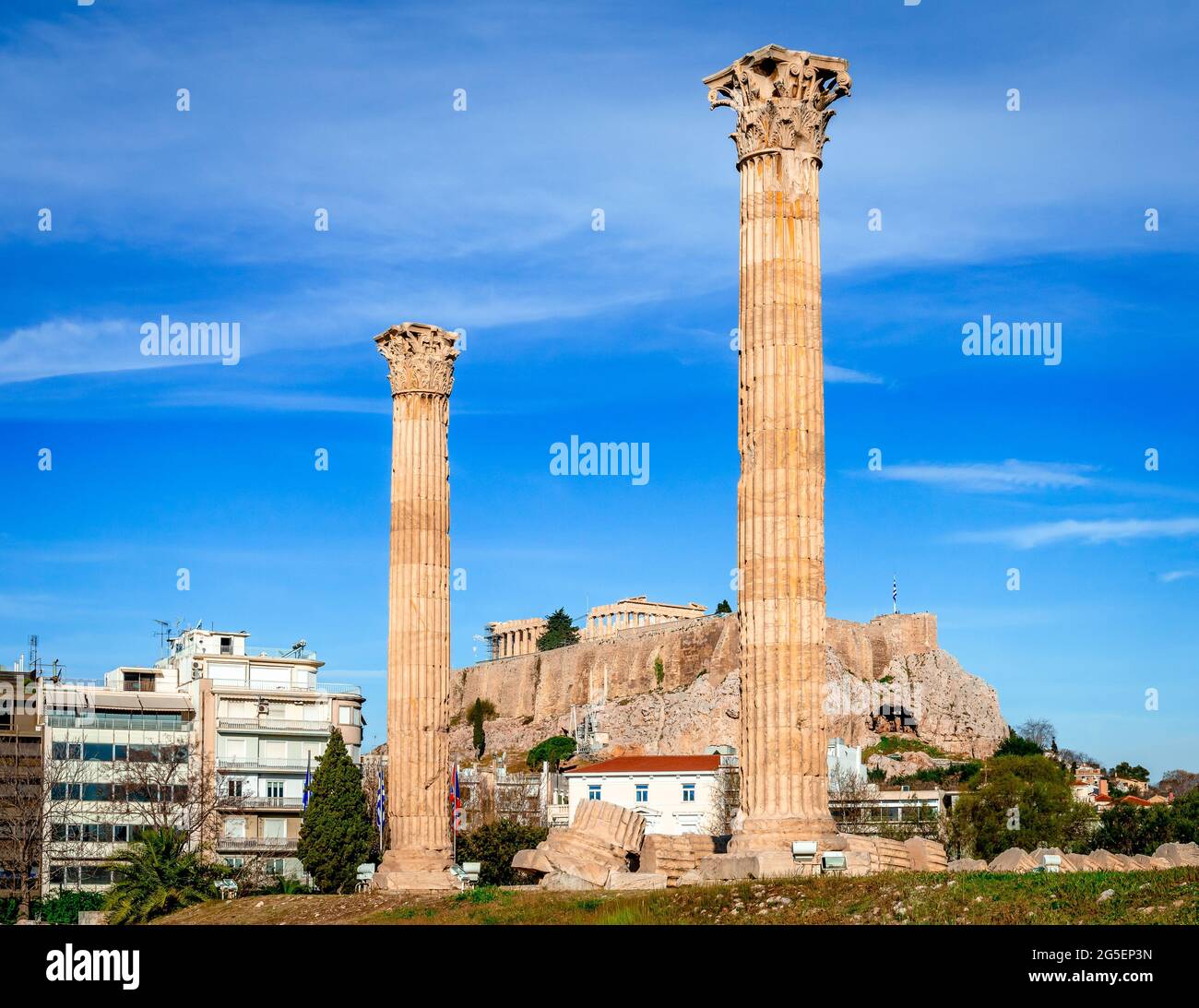 Athen, Griechenland: Zwei der verbleibenden Säulen des Tempels des olympischen Zeus mit der Akopolis im Hintergrund. Stockfoto