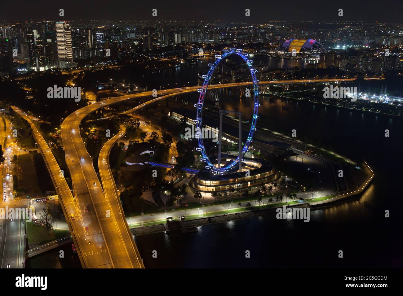 Blick auf den Singapore Flyer und die Marina Bay nach Einbruch der Dunkelheit Stockfoto