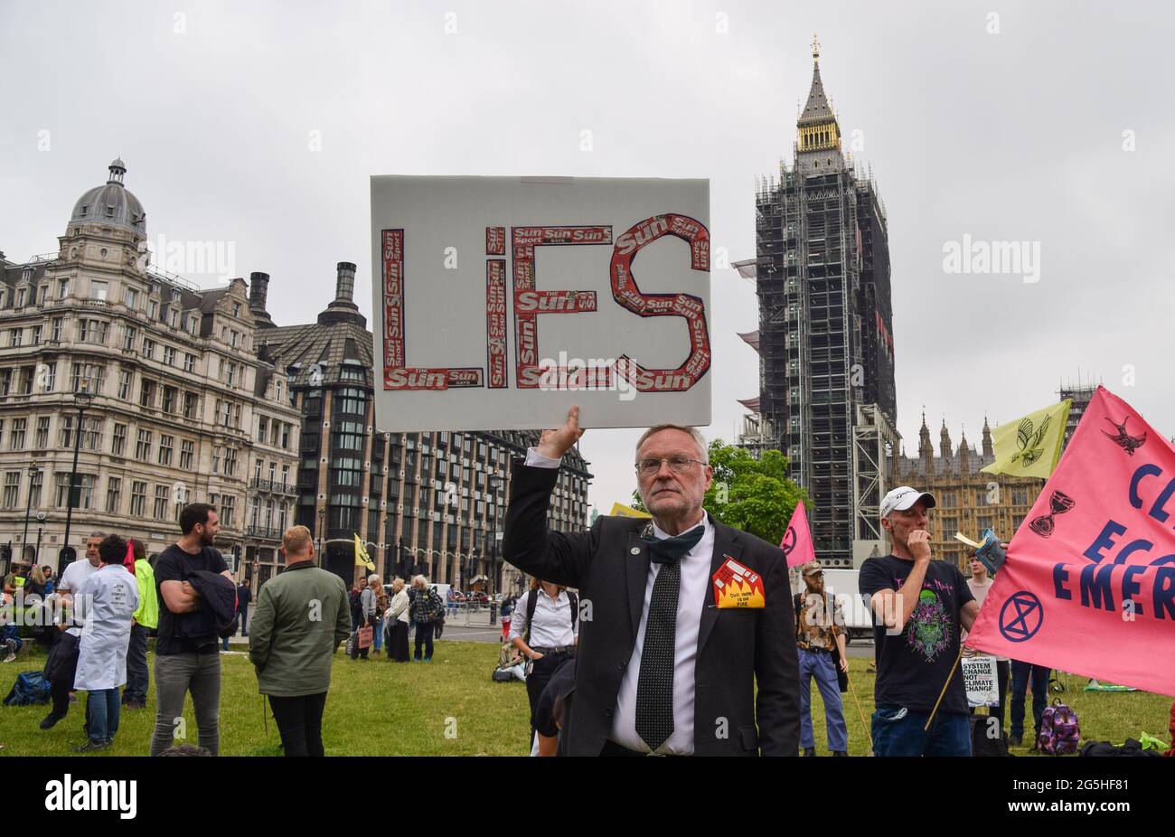 London, Großbritannien. Juni 2021. Ein Demonstrant hält ein Plakat mit Lügen mit dem Sun Zeitungslogo während des Protestes der Freien Presse auf dem Parliament Square.Extinction Rebellion Demonstranten marschierten aus Protest gegen Korruption vom Parliament Square zum britischen Nachrichtenhauptsitz, das Rupert Murdoch gehört, Und die ungenaue und unzureichende Berichterstattung über die Klima- und Umweltkrise durch mehrere große britische Zeitungen, die sich im Besitz von Milliardären befinden. Kredit: SOPA Images Limited/Alamy Live Nachrichten Stockfoto