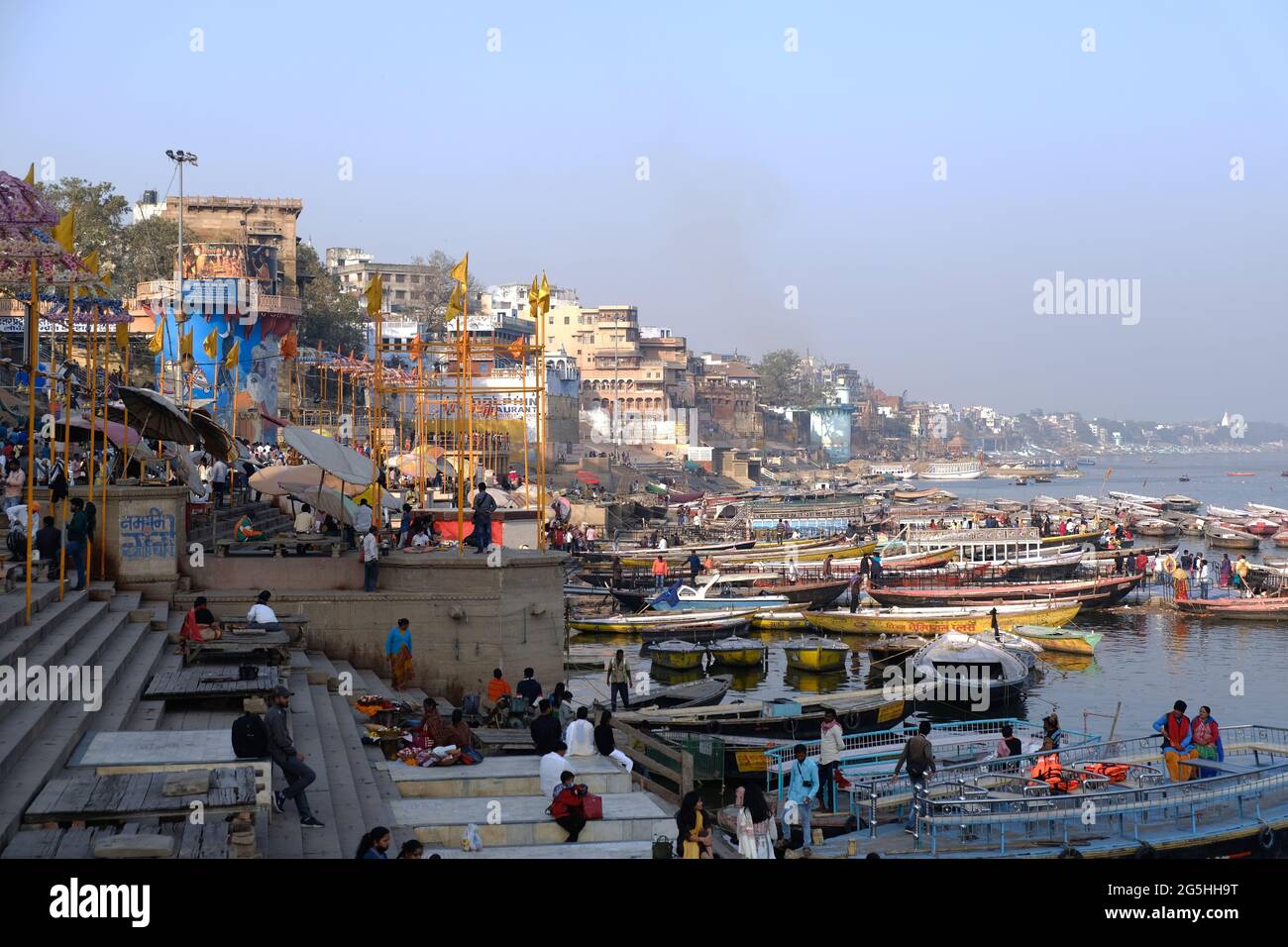 VARANASI, INDIEN, 05. Februar 2021, Morgenansicht auf heiligen Ghats von Varanasi entlang des Ganges Flusses mit Booten, Indien Stockfoto