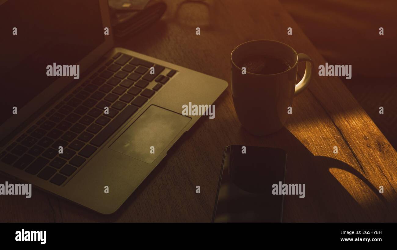 Morgenkaffee in dunklem Home-Office-Innenraum, Low-Key-Bild mit selektivem Fokus Stockfoto