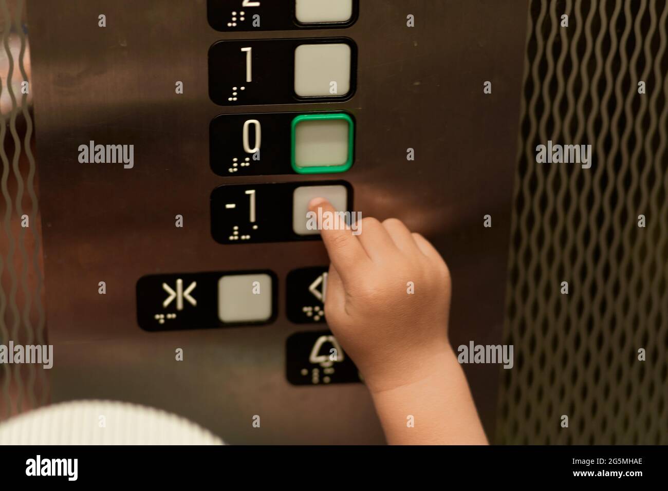 Baby ruft den Aufzug an. Kleinkind lernt Zahlen oder Neugier Kind Konzept. . Hochwertige Fotos Stockfoto