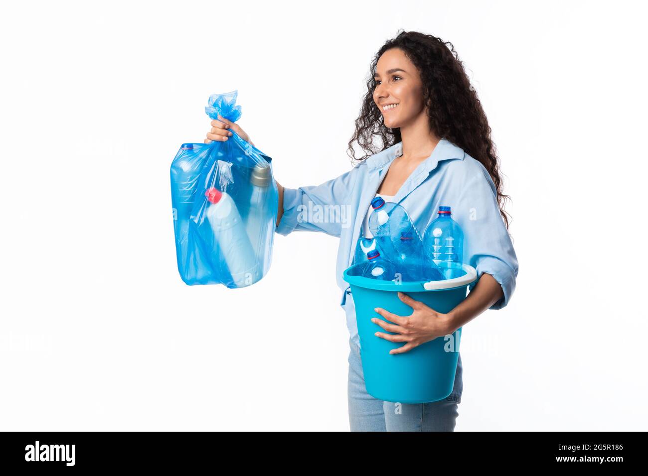 Happy Female Giving Bag Mit Plastikmüll Zur Seite Schauen, Studio Stockfoto