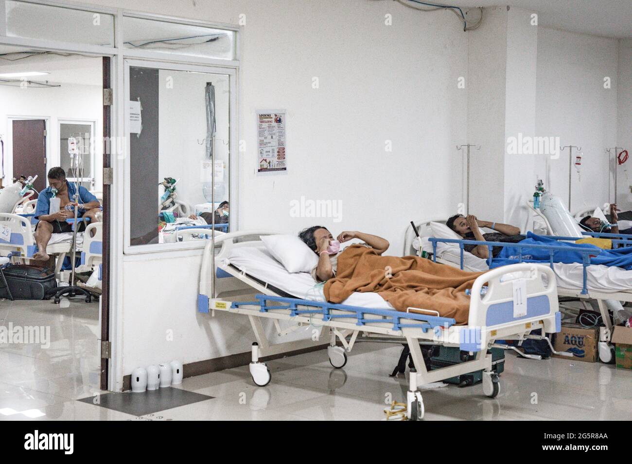 Jakarta, Indonesien. Juni 2021. Ein COVID-19-Patient mit Atembeschwerden verwendet einen Sauerstoffschlauch im Wisma Atlet Covid-19 Emergency Hospital Complex. Indonesien hat einen signifikanten Anstieg der COVID-19-Fälle erlebt, wobei durchschnittlich mehr als 21,000 Fälle pro Tag den Druck auf Krankenhäuser ausübten, einschließlich in Jakarta und Umgebung, wo die meisten Krankenhausbetten voll sind. (Foto von Risa Krisadhi/SOPA Images/Sipa USA) Quelle: SIPA USA/Alamy Live News Stockfoto