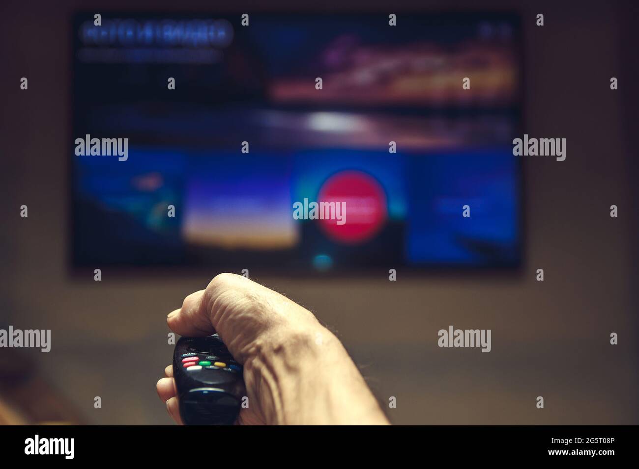Männliche Hand, die TV-Fernbedienung. Stockfoto