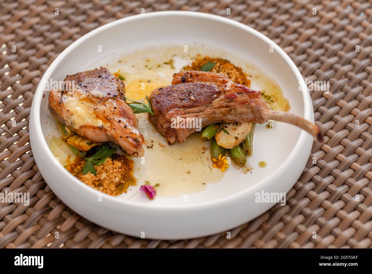 Frisch gegrilltes Lammsteak auf weißem Teller im Freiluftrestaurant am Sommertag Stockfoto