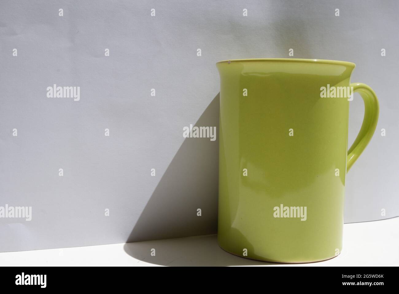 Grüner Kaffeebecher im Freien mit weißem Hintergrund Stockfoto