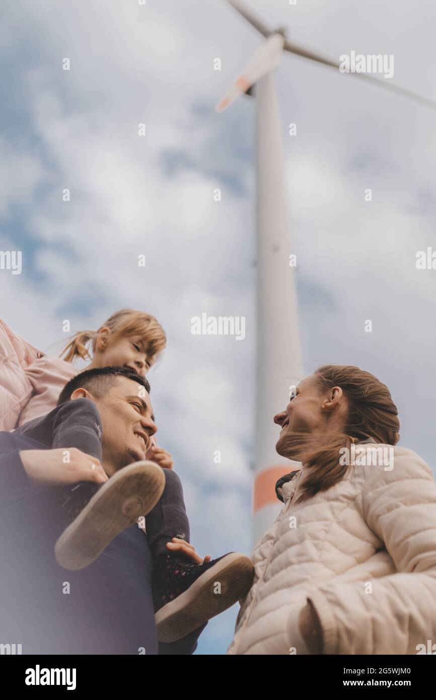 Junge Familie auf dem Hintergrund der Windmühlen. Stockfoto