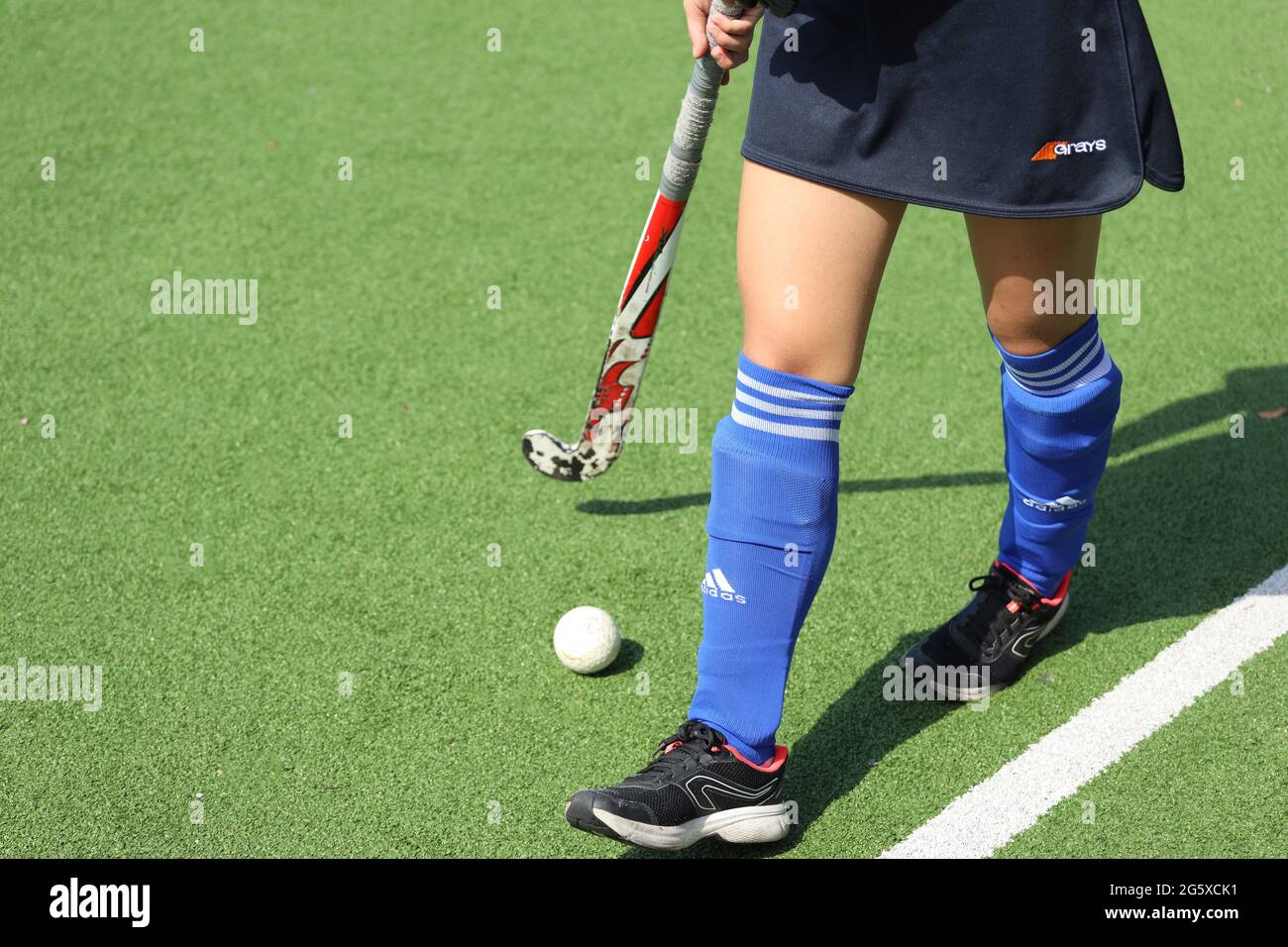Russland. Vyborg 06.06.2021 Mädchen mit einem Stock und einem Ball steht auf dem Feld. Hockey auf dem Rasen Stockfoto