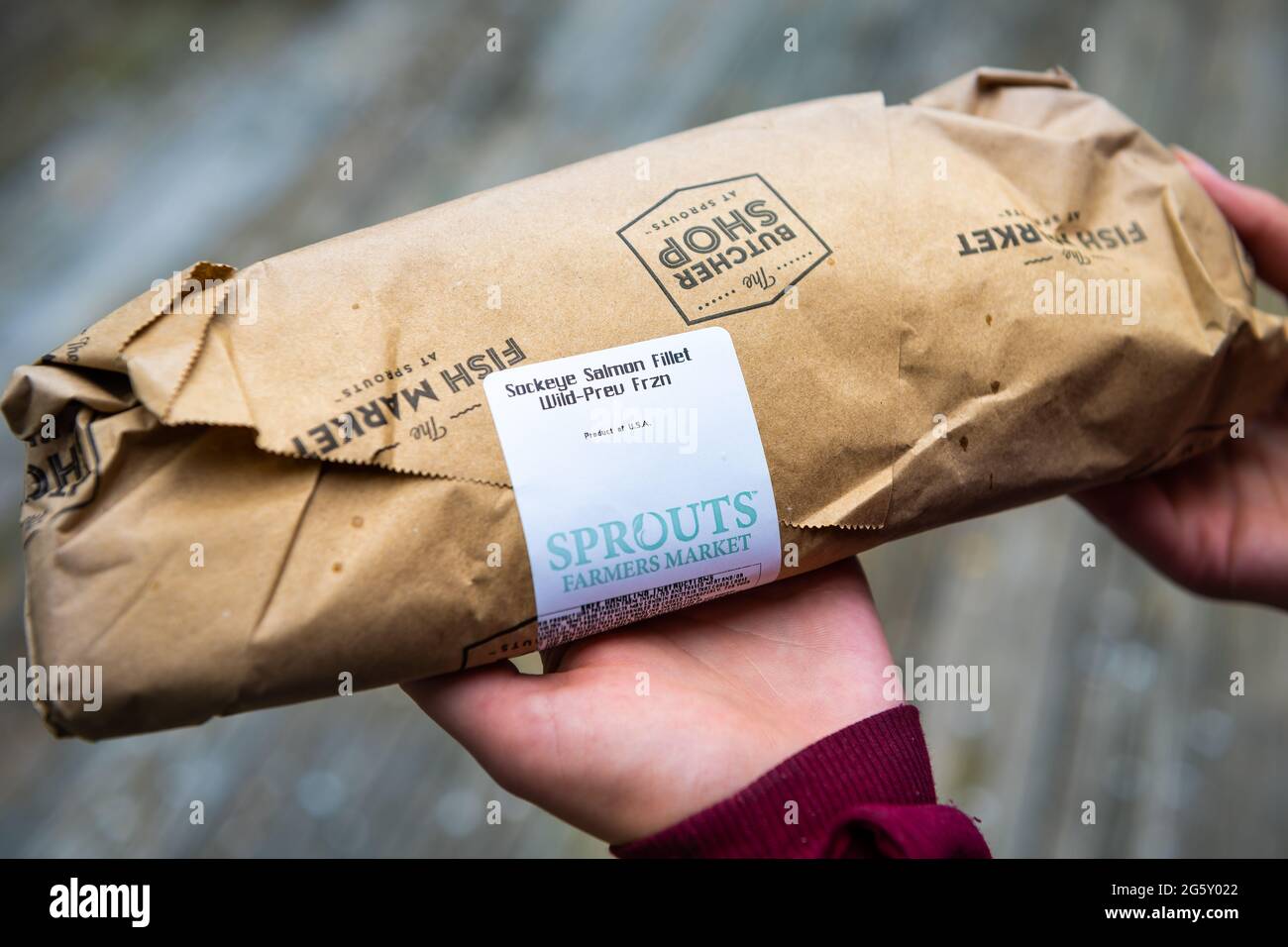 Herndon, USA - 12. April 2021: Roher Sockeye-Lachs zuvor gefrorener Etikettentext verpackt gekauft auf Sprossen Farmers Market von Metzgerhand Holdi Stockfoto