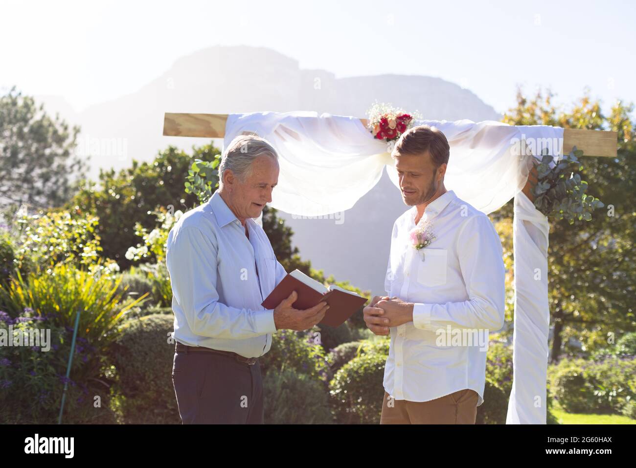 Kaukasischer Bräutigam heiratet und spricht mit dem Hochzeitsoffizier Stockfoto