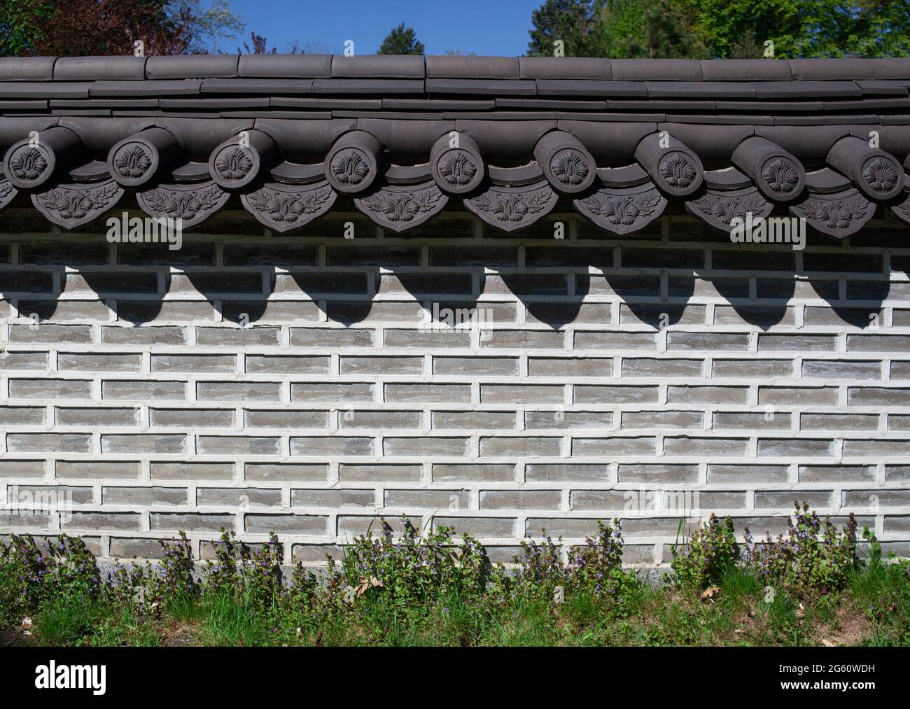 Ziegelzaun. Backstein Muster Textur Hintergrund. Dachziegel am Steinzaun. Wand im antiken Stil dekoriert. Stockfoto