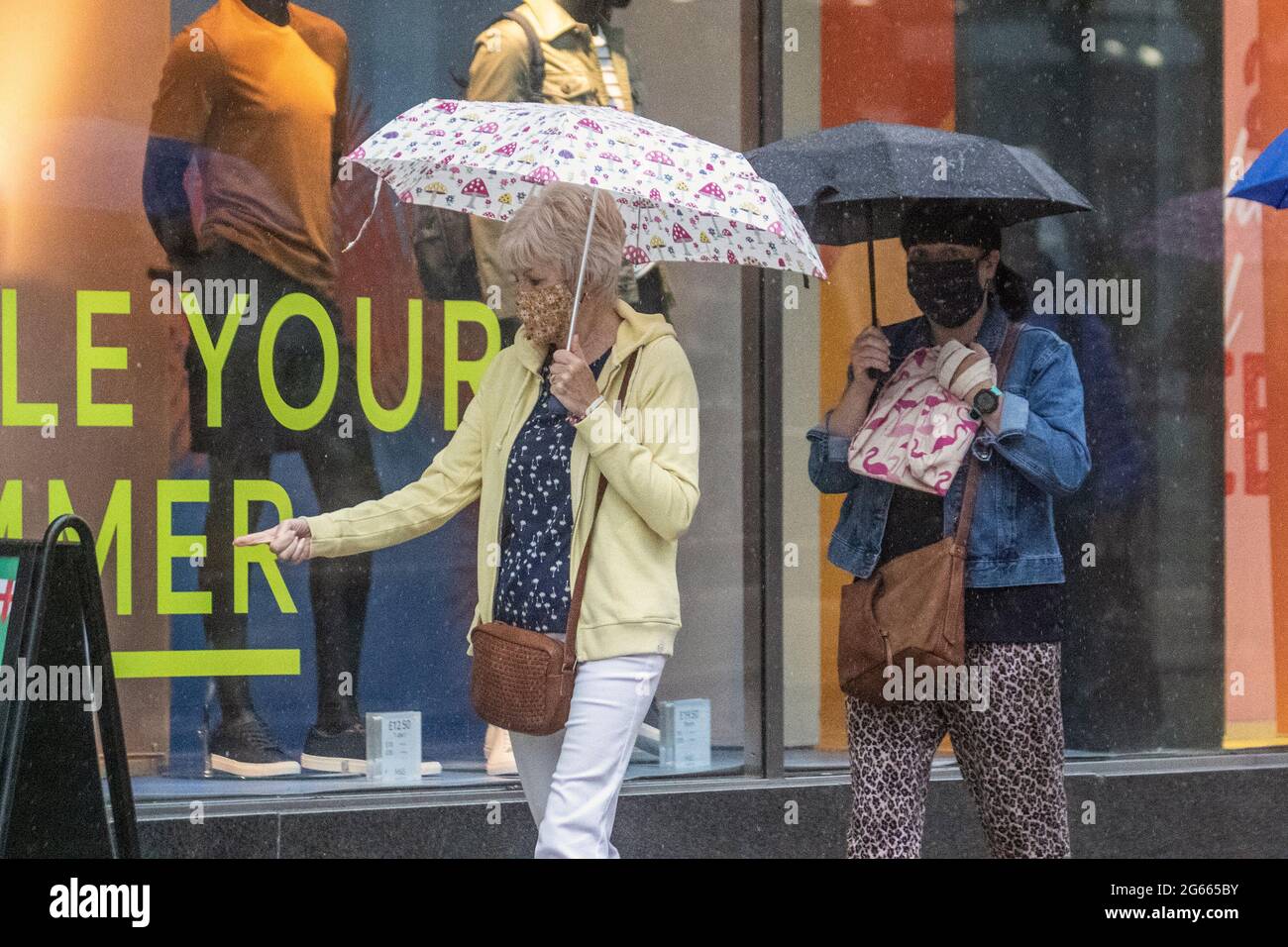 Preston, Lancashire. UK Wetter 3. Juli 2021. Sommerliche Mode und sommerliche Regengüsse für Geschäfte, Shopper und Leute, die im Stadtzentrum einkaufen. Für viele wird heute und morgen starker Regen und Gewitter prognostiziert. Heute Abend werden starke und gewittere Schauern in ganz Großbritannien weiterhin verbreitet sein. Kredit; MediaWorldImages/AlamyLiveNews Stockfoto