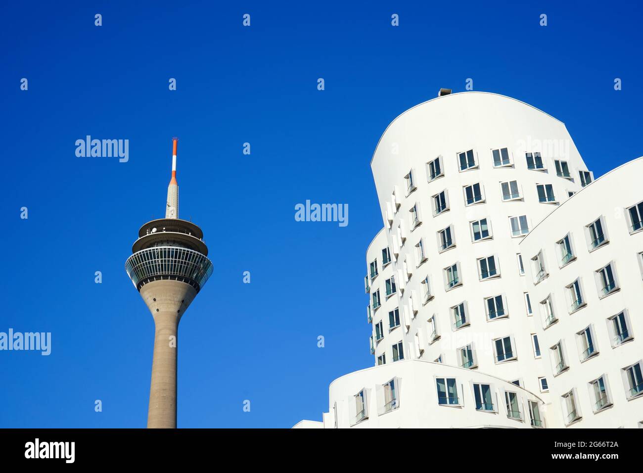 Weißes Gebäude des US-amerikanischen Stararchitekten Frank O. Gehry im Neuen Zollhof, Medienhafen und dem Düsseldorfer Wahrzeichen Rheinturm. Stockfoto