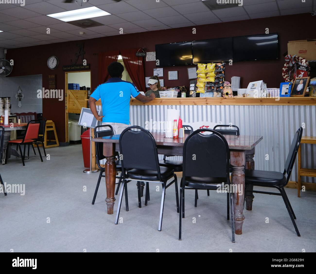 Afroamerikanischer Mann oder schwarzer Mann am Bestellschalter in der Kleinstadt, dem Land, dem Restaurant, dem Bones Backstreet BBQ in Clanton Alabama, USA. Stockfoto