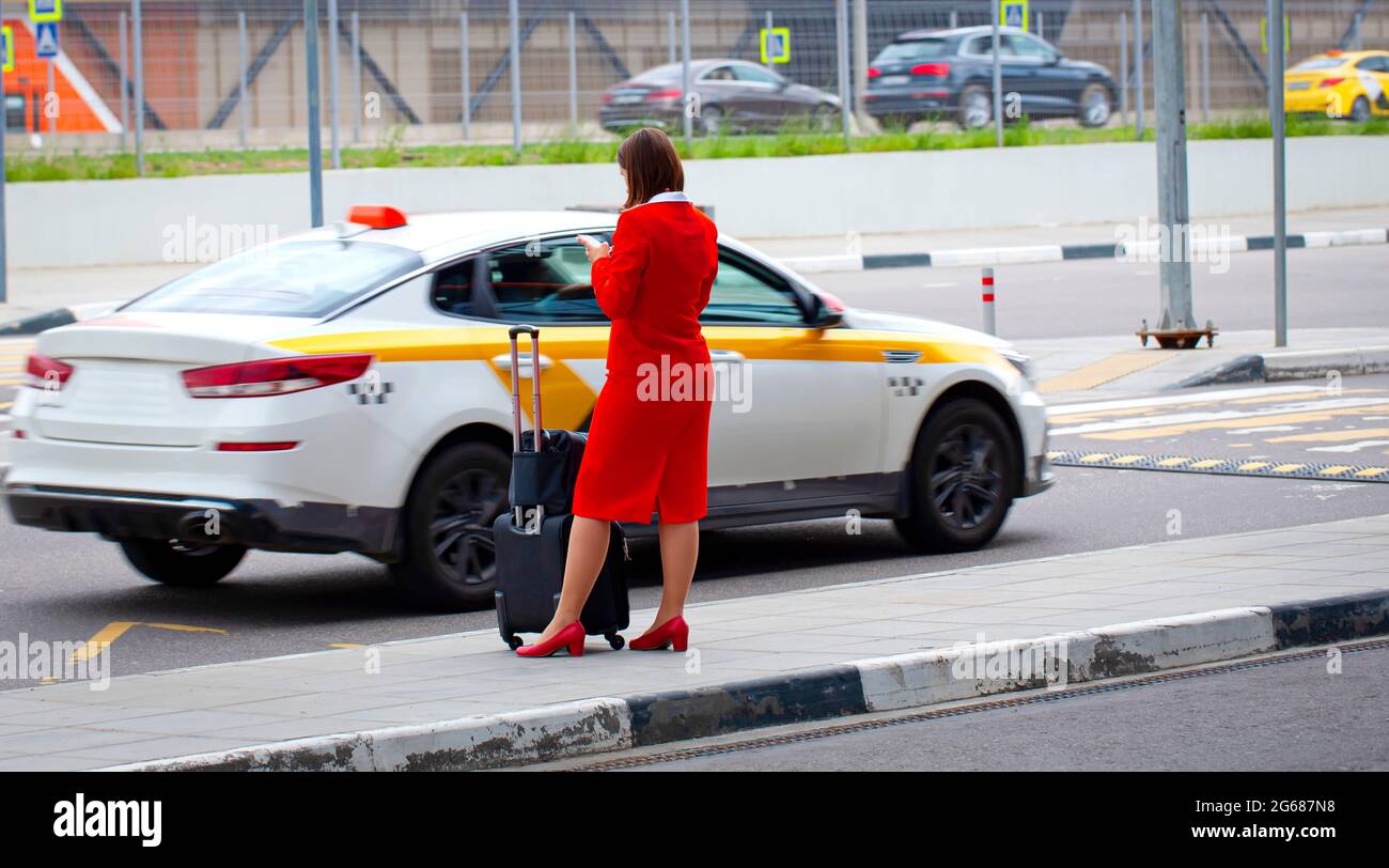 Selektiver Fokus. Eine weibliche Flugbegleiterin verlässt ein Hotel auf dem Weg zum Flughafen Stockfoto