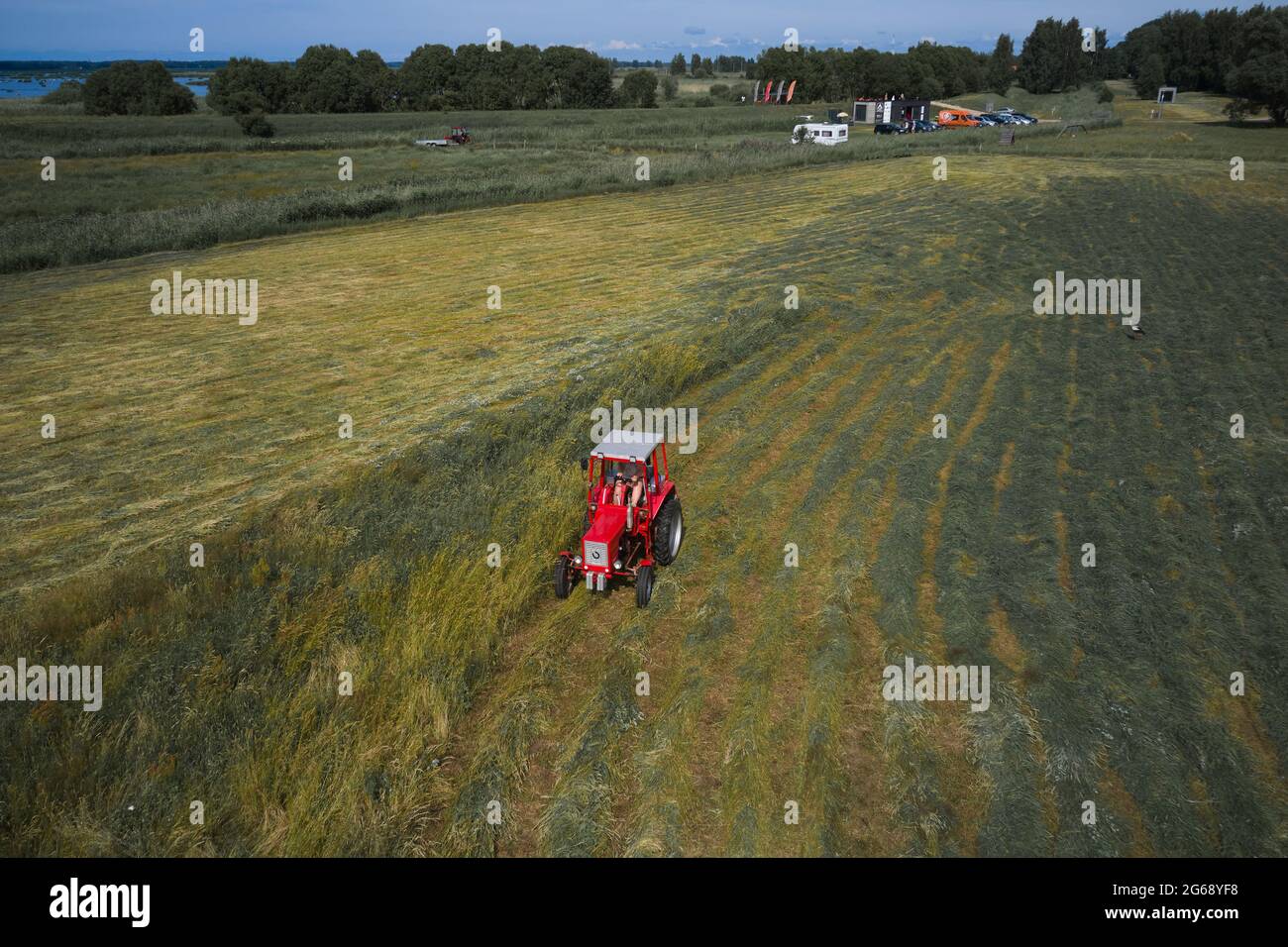 Kleine Landwirtschaft mit Traktor und Pflug im Feld Stockfoto