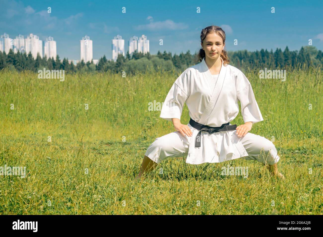 Teen Mädchen Durchführung Karate Kata im Freien in kiba-dachi Haltung Stockfoto