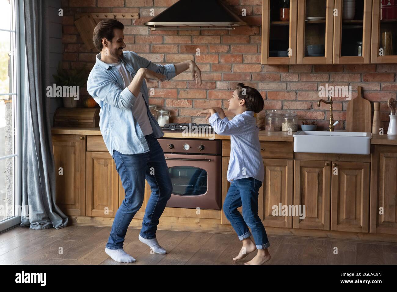 Glücklich Vater Lehre aufgeregt niedlich Vorschulkinder Sohn zu tanzen Stockfoto