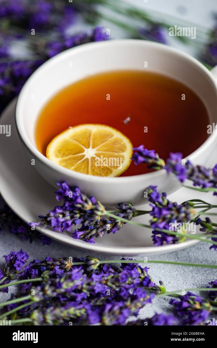 Tasse Tee mit einer Scheibe Zitrone, Lavendelblüten Stockfoto
