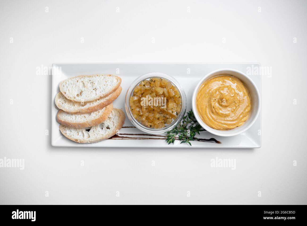 Nahaufnahme von Gänseleber-Pastete mit Apfelchutneys und Brot auf weißem Hintergrund Stockfoto