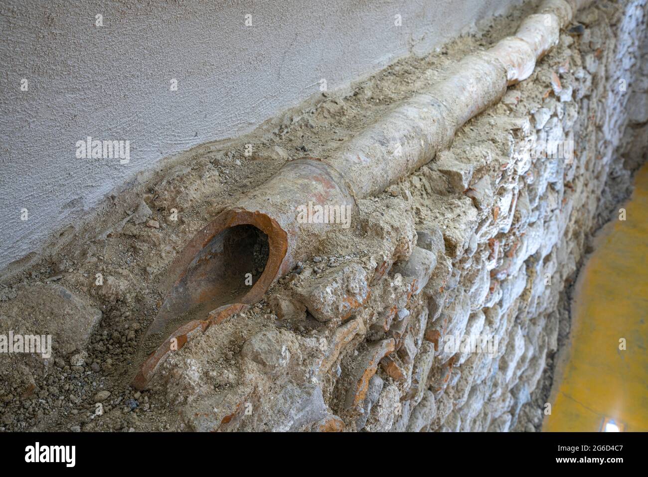Alte Mauern mit Überresten von Wasserkanälen, die bei archäologischen Ausgrabungen unter dem Acatterale von San Pietro Apostolo gefunden wurden. Isernia, Molise Stockfoto