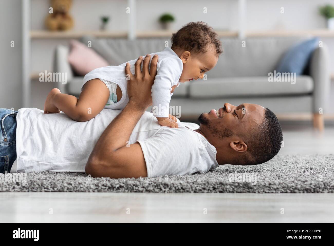 Die Liebe des Vaters. Happy Young Black Dad Bonding Mit Neugeborenen Baby Zu Hause Stockfoto