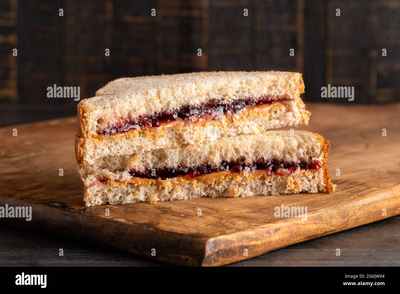 Ein Erdnussbutter- und Traubenjelly-Sandwich auf einem hölzernen Schneidbrett Stockfoto