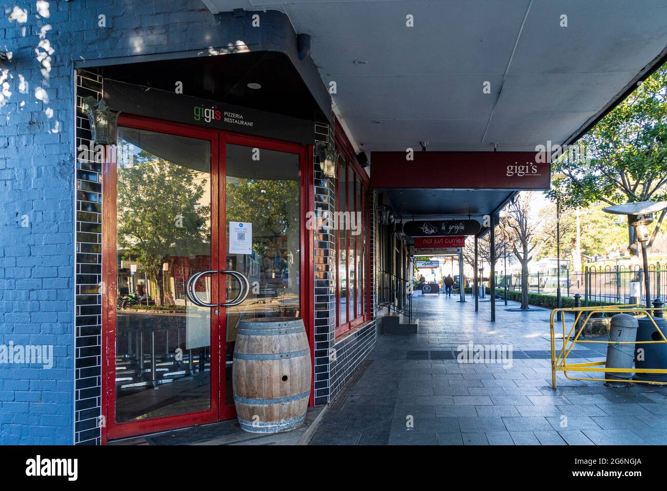 Reflexionen in Fenstern einer geschlossenen Bar auf einer verlassenen Straße in Balmain, Sydney, Australien während der Pandemiesperre Stockfoto