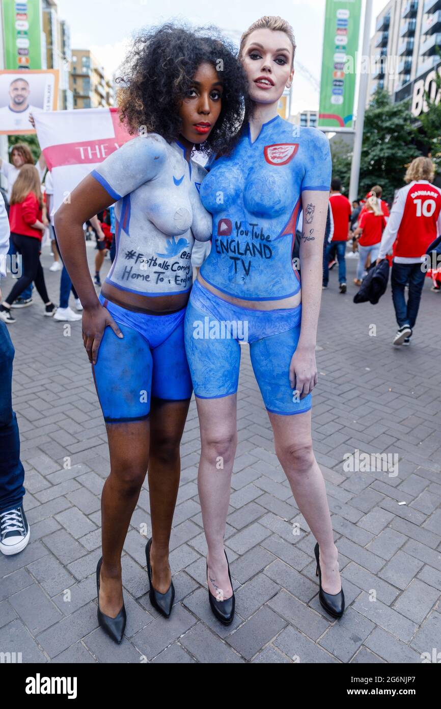 Wembley Stadium, Wembley Park, Großbritannien. Juli 2021. 2 Damen, die nur Slips und Körperbemalung tragen, posieren vor dem Halbfinale der UEFA EURO 2020 im Wembley-Stadion auf olympischem Weg. 60,000 Fans werden im Wembley Park zusehen, wie England beim Halbfinalspiel der UEFA EURO 2020 im Wembley Stadium Dänemark spielt. Amanda Rose/Alamy Live News Stockfoto