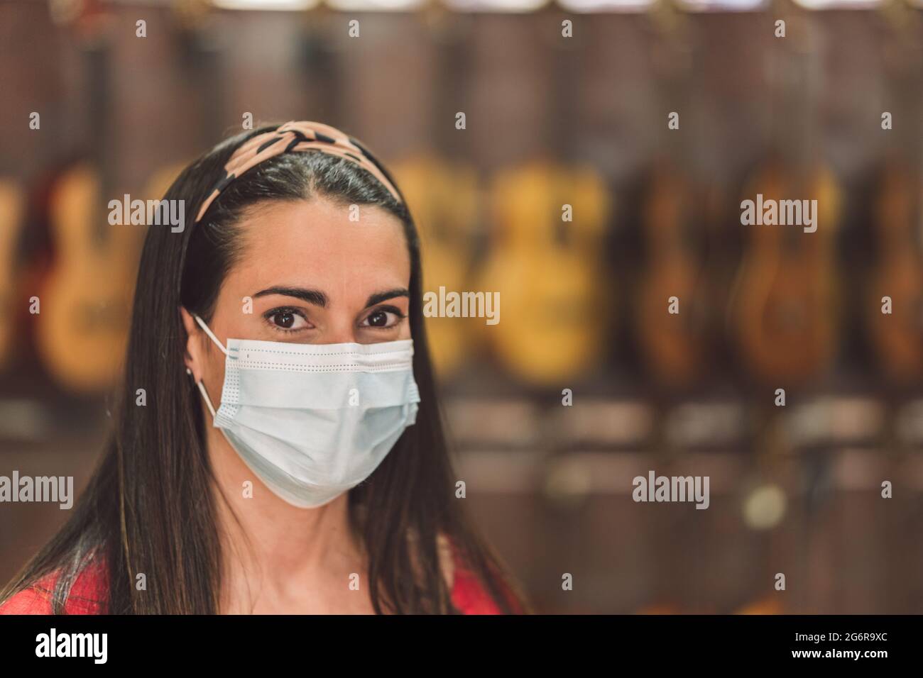 Porträt einer Frau mit Maske in einem Geschäft Stockfoto