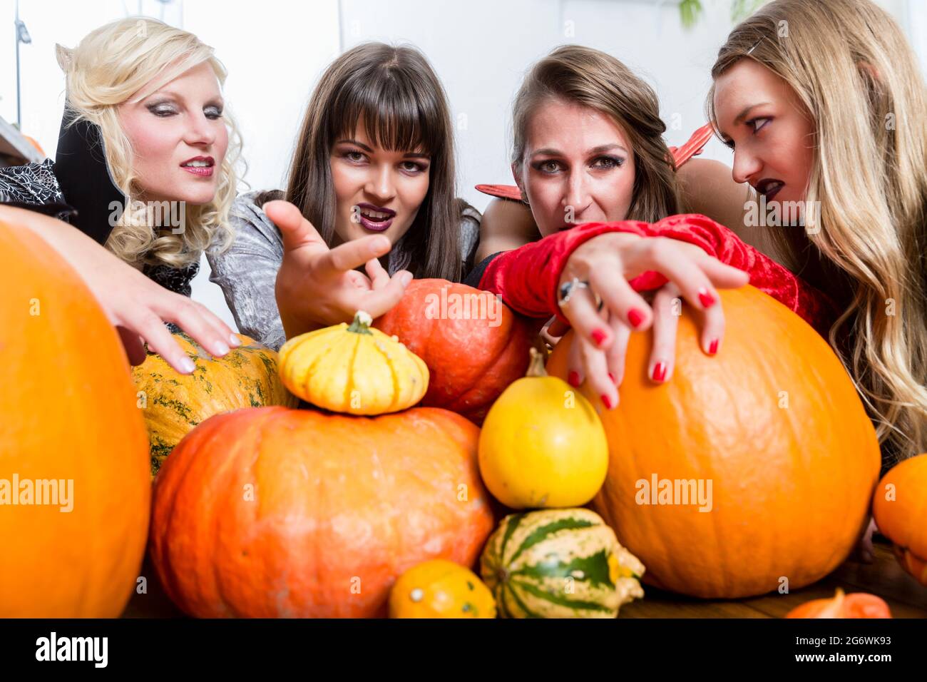Drei junge und schöne Frauen, lustige Kostüme als Hexen ihre schädliche Kräfte an Halloween Stockfoto