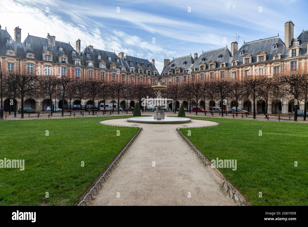 Der Place des Vosges, der älteste geplante Platz in Paris, gesäumt von Bäumen und roten Ziegelhäusern, wurde 1612 von Henri IV. Erbaut Stockfoto