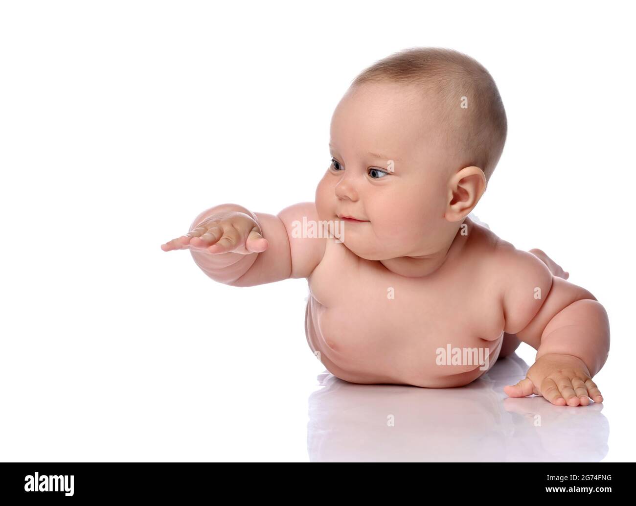 Kleinkind Baby Mädchen Kind in Windel liegt auf ihrem Bauch, Bauch, kriechen Hand nach oben und schaut zur Seite Stockfoto