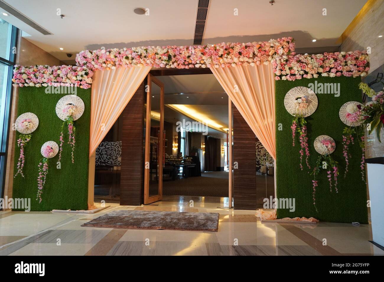 Florale Hochzeit Dekoration Element. Lichter, Eingangstor, Dusche, Blumen, Bühne für Paare. Nahaufnahme wunderschöne Blumen Hochzeitsbogen am Eingang des Stockfoto