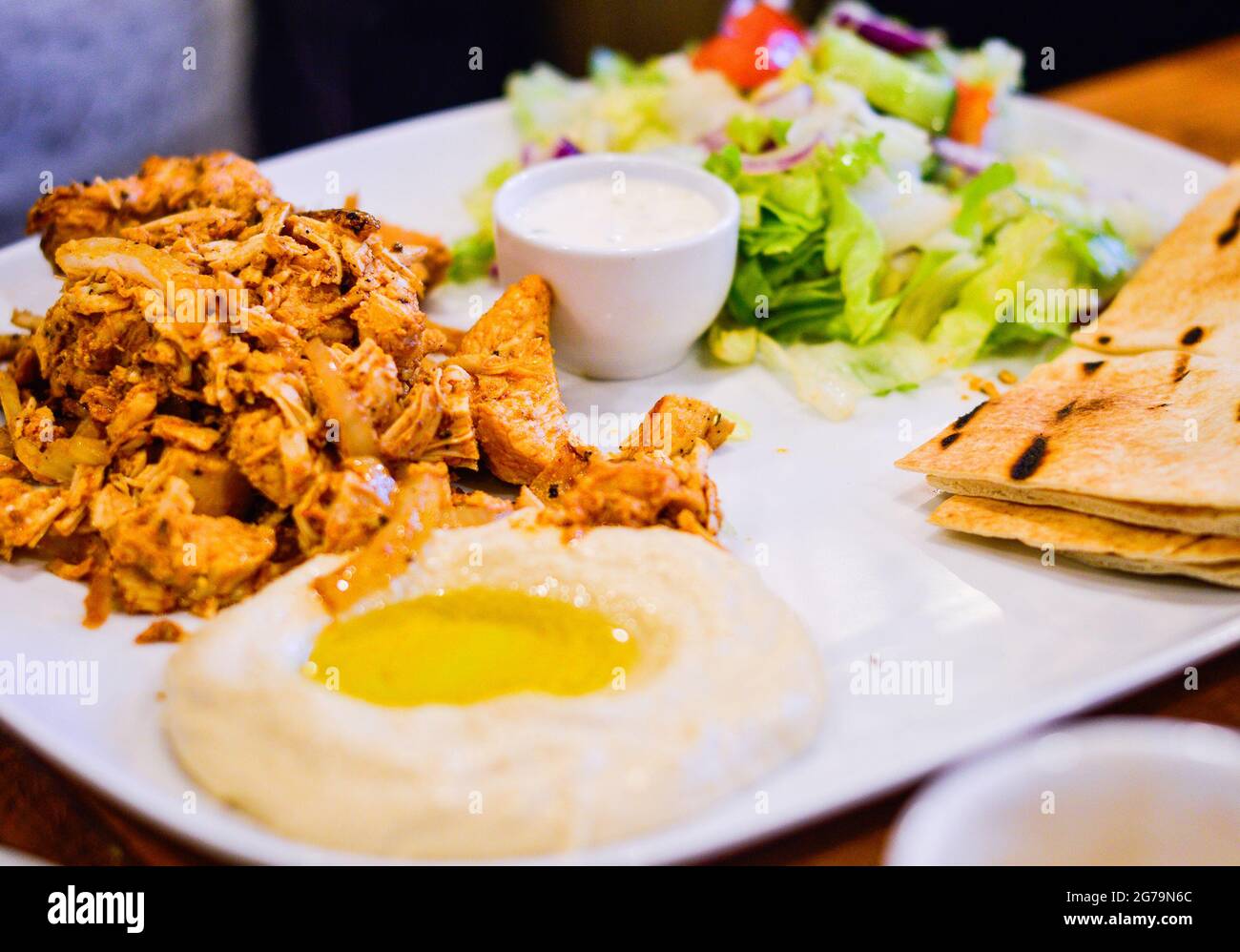 Gegrilltes mariniertes Huhn mit Hummus, Pitta-Brot und Salat. Authentisches nahöstliches Essen aus dem Restaurant. Stockfoto