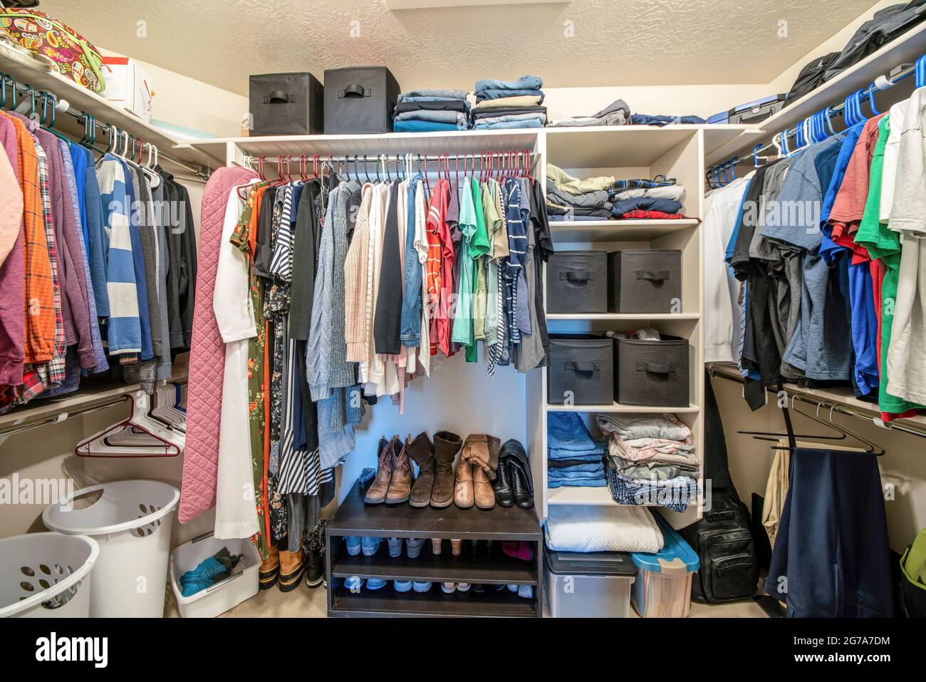 Organisierte kleine begehbaren Kleiderschrank mit Kleidung und Bettwäsche Aufbewahrungsboxen Stockfoto