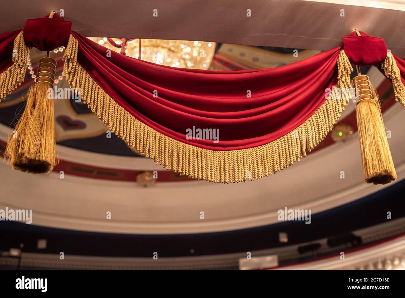 Vintage-Vorhänge aus rotem Samt mit goldenen Zinnmuscheln im Theater Stockfoto