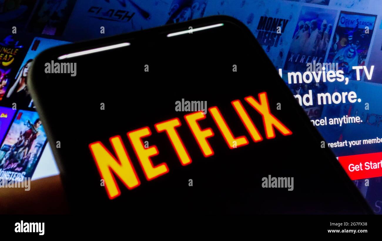 SAO PAULO, BRASILIEN - 03. Juli 2021: Netflix-Logo sichtbar auf dem Smartphone-Bildschirm und Website-Homepage im Hintergrund . Stockfoto