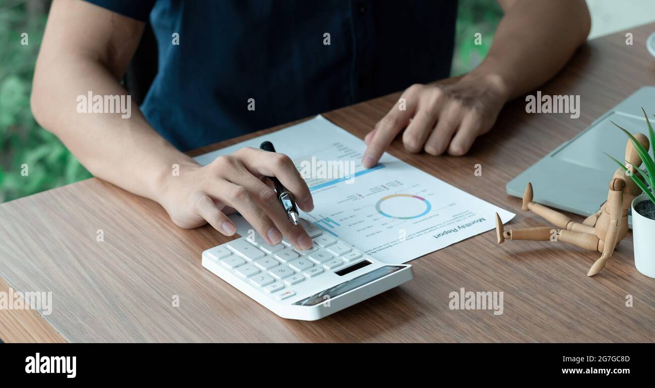 Geschäftsmann arbeiten mit finanziellen Daten Hand mit Rechner und Schreiben notieren Sie sich mit rechnen. Business Finanz- und Rechnungslegungskonzept Stockfoto