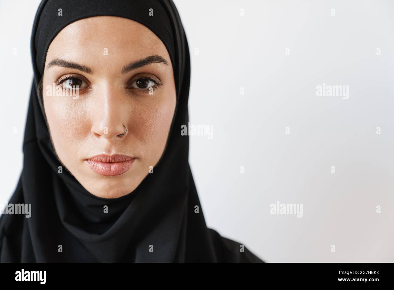 Ein Porträt einer muslimischen Frau mit durchbohrter Nase im weißen Studio Stockfoto