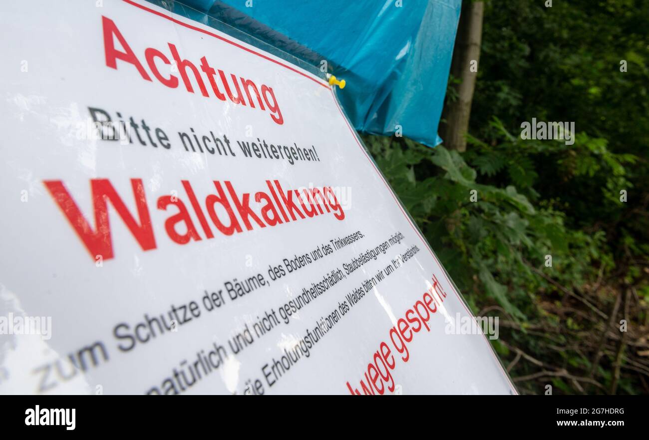 Hausdorf, Deutschland. Juli 2021. „Achtung. Gehen Sie bitte nicht weiter! Waldkalken' steht auf einem Schild entlang eines Weges im Waldgebiet Falkenau. Der Kalk, der per Hubschrauber auf das Waldgebiet aufgebracht wird, soll Schäden durch sauren Regen im Waldboden kompensieren. Die sauren Böden können zu Verfärbung von Blättern und Nadeln führen. Im Freistaat wurden seit 1986 rund 407,000 Hektar Wald gekalkt. Quelle: Hendrik Schmidt/dpa-Zentralbild/dpa/Alamy Live News Stockfoto