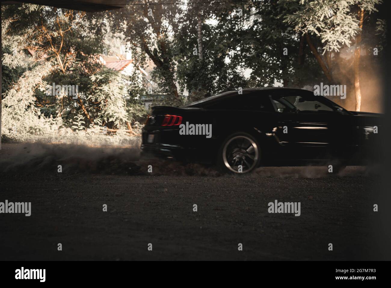 Schwarzer Ford Mustang driftet unter der Brücke. Stockfoto