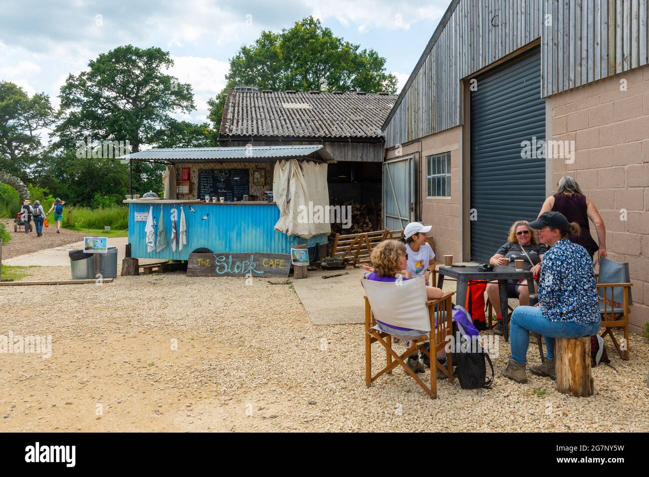 Besucher, die im Sommer am Stork Cafe Kiosk auf dem Knepp Estate Wildland Rewilding-Gelände in West Sussex, England, Großbritannien, Erfrischungen genießen Stockfoto