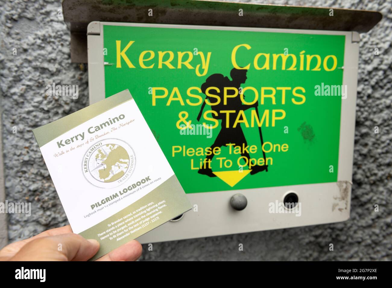 Hand mit einem Faltblatt in einem Kerry Camino Pässe und Stempel Pilgrim Logbook Box in der St. John's Church in Tralee, County Kerry, Irland Stockfoto